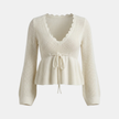 FJØRNA women's knitted zip cardigan with scalloped tie front and peplum design, perfect for stylish layered looks.