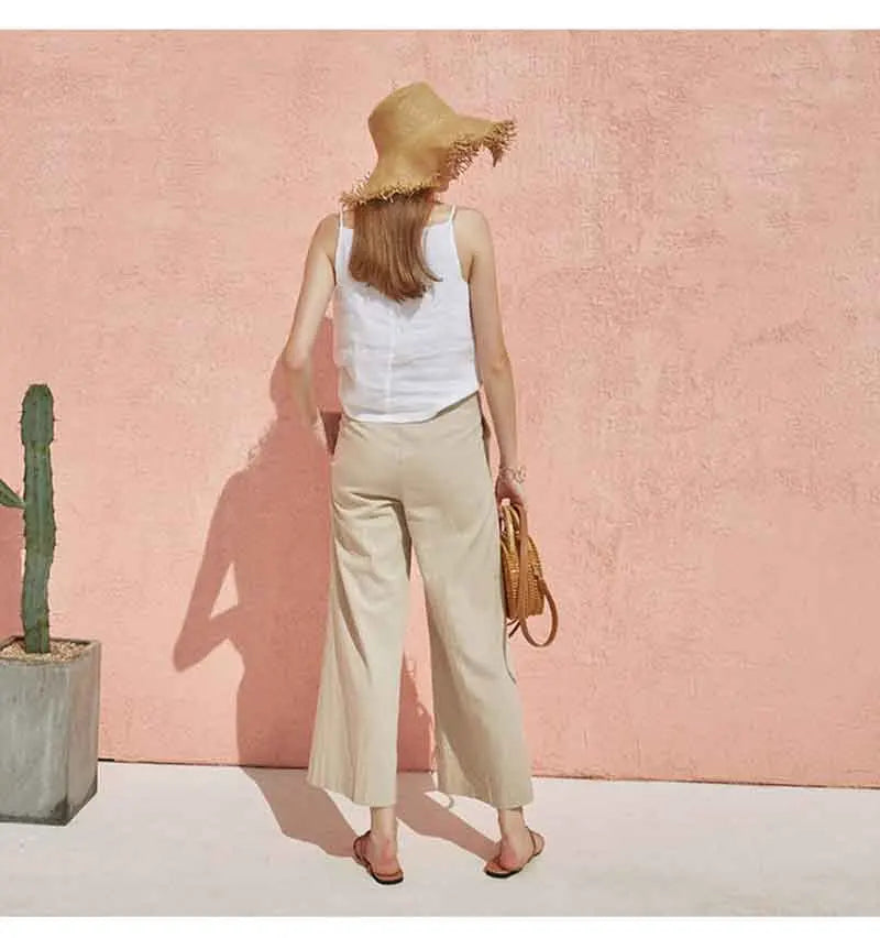 FJØRNA satin-trimmed linen cami top with delicate straps and soft linen fabric, shown in a light-colored, elegant design.