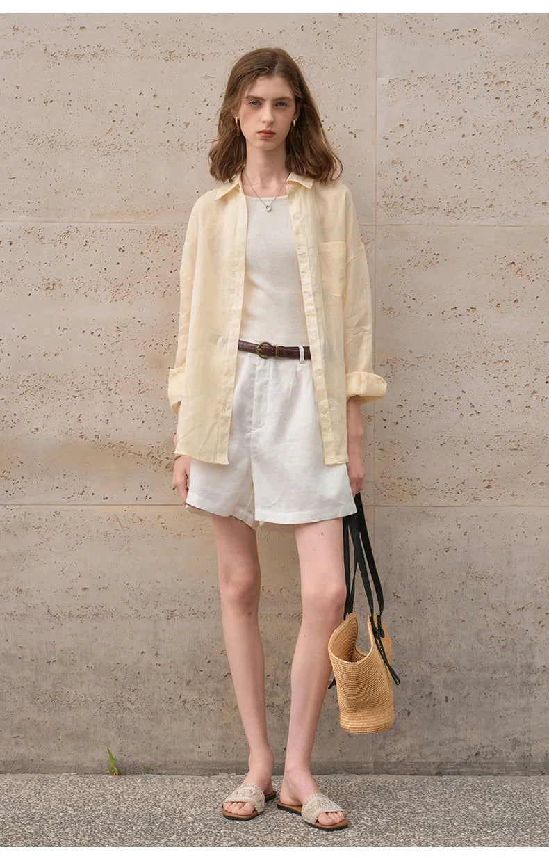 FJØRNA women's linen shirt, light and breathable top with a relaxed fit, shown in natural fabric texture and casual style.