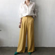 FJØRNA women's linen shirt with open collar, lightweight and breathable top, shown in a relaxed fit on a model.