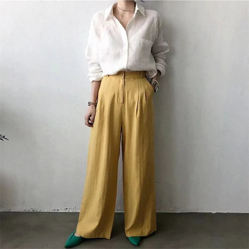 FJØRNA women's linen shirt with open collar, lightweight and breathable top, shown in a relaxed fit on a model.