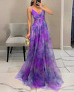Elegant floral V-neck maxi dress for women by FJØRNA, featuring a flowing silhouette and vibrant floral pattern.