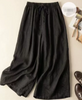 Lightweight women's summer trousers by FJØRNA featuring wide-leg, breathable, flowy fabric for a comfortable warm-weather look.