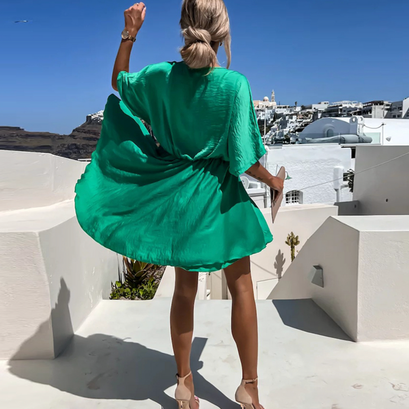 FJØRNA stylish summer mini dress for casual weddings, featuring lightweight fabric and a flared silhouette perfect for warm weather.