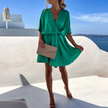 FJØRNA stylish summer mini dress, casual wedding dress in lightweight fabric, featuring a relaxed fit and feminine design.