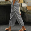 FJØRNA women's linen summer trousers with high waist and tapered fit, shown in a breathable, light fabric suitable for warm weather.