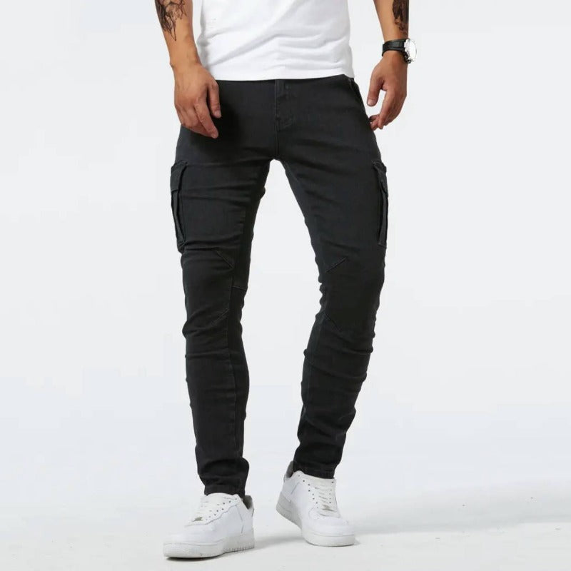 Men's denim cargo pants by FJØRNA with 4-way stretch, versatile casual style, featuring multiple pockets and relaxed fit.