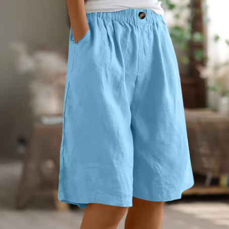 FJØRNA Renee™ Comfort Shorts, soft fabric with elastic waistband and relaxed fit, shown in a casual indoor setting.