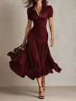 FJØRNA Zaffira pleated white midi dress with a fitted bodice and flowing skirt, perfect for elegant occasions.