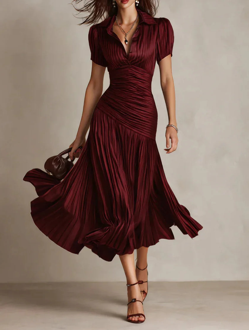 FJØRNA Zaffira pleated white midi dress with a fitted bodice and flowing skirt, perfect for elegant occasions.