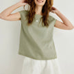 FJØRNA Petal Sleeve Linen T-Shirt in light fabric with petal sleeve design, showcasing a relaxed fit and natural linen texture.