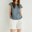 FJØRNA Petal Sleeve Linen T-Shirt showing soft linen fabric and petal-sleeve design on a light-colored backdrop.