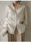 FJØRNA women's linen pleated shirt, lightweight and breathable top with a relaxed fit, displayed on a hanger.