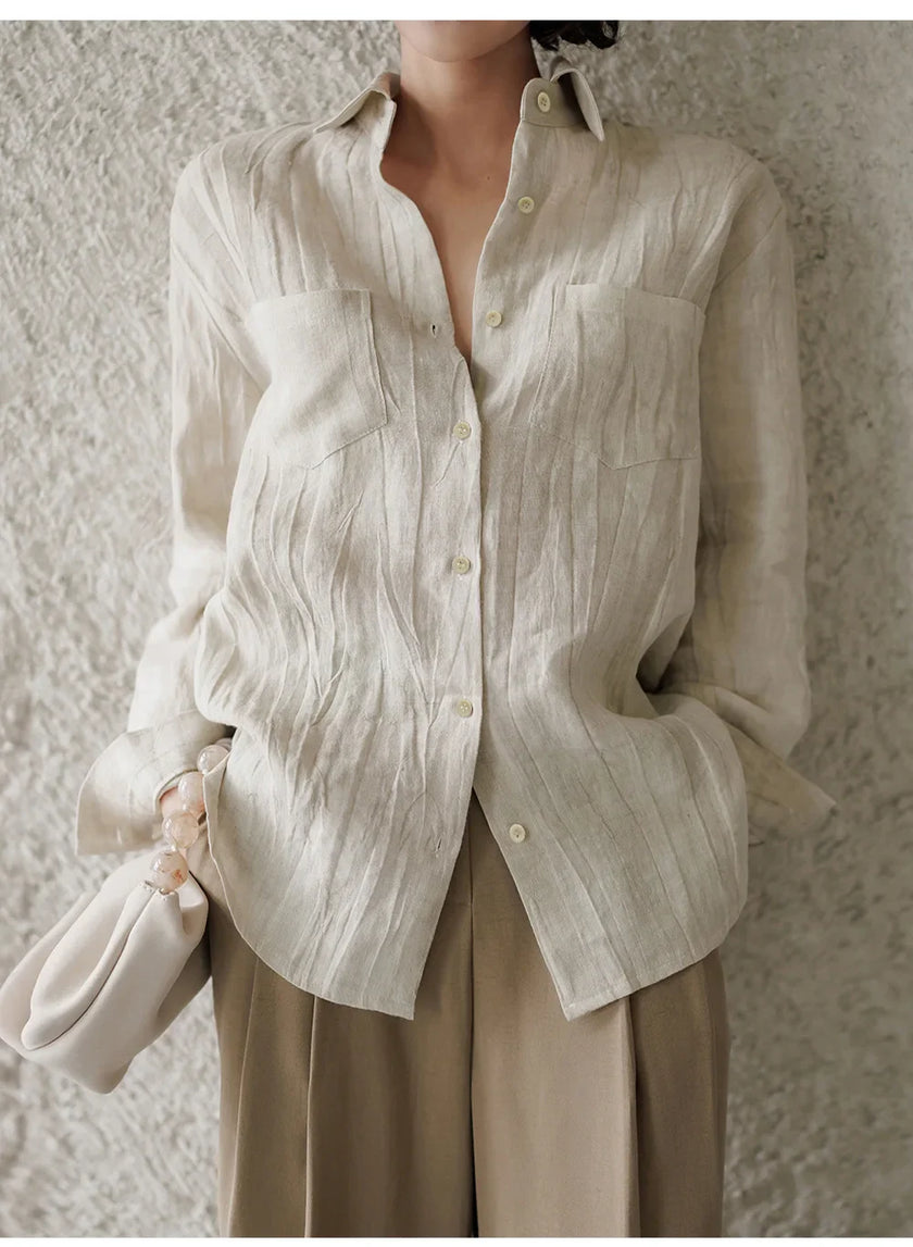 FJØRNA women's linen pleated shirt, lightweight and breathable top with a relaxed fit, displayed on a hanger.