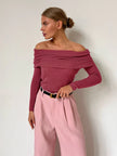 Off-shoulder ribbed knit top for women by FJØRNA, showcasing a fitted, textured design in soft knit fabric.