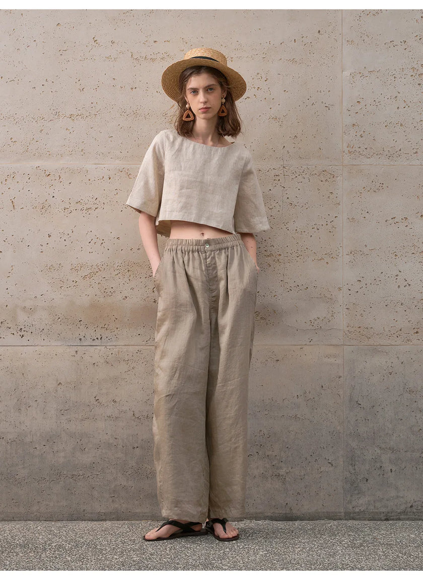 FJØRNA women's linen crop top with short sleeves, lightweight and breathable, shown in a natural relaxed fit.