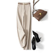 Women’s wool trousers by FJØRNA featuring wide-leg, high-waist design, shown in a natural pose on a white background.