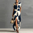 FJØRNA Victoria printed button-down maxi dress in white with floral patterns, flowing fabric, and long sleeves.