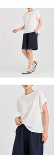 FJØRNA oversized tee with rolled cuffs, relaxed fit, and soft fabric, shown in a casual, stylish streetwear look.