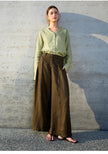 Women's linen V-neck shirt by FJØRNA, shown in natural light with a relaxed fit and classic collar detail.