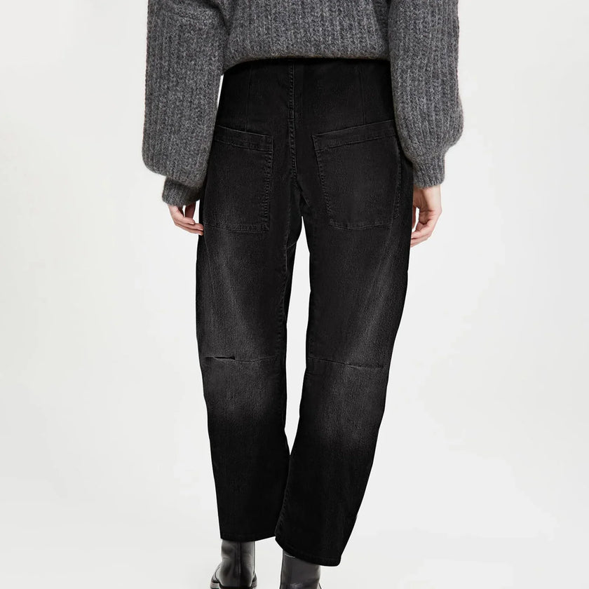 FJØRNA women's denim jeans with a relaxed barrel leg fit, showcasing classic blue denim and stylish casual design.