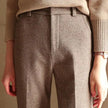 FJØRNA women's wool blend trousers, stylish pants with a tailored fit, shown in a neutral color on a model.