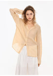 FJØRNA women's linen V-neck shirt, lightweight and breathable top with long sleeves, natural fabric texture, in neutral color.