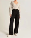 FJØRNA women's wide-leg high-waist trousers with relaxed fit, stylish pants featuring a comfortable waistband and flowing silhouette.