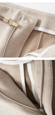 Women's wide-leg wool trousers by FJØRNA featuring high waist and tailored fit, shown in a stylish, neutral color.