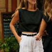 FJØRNA women's linen crop top, lightweight and stylish, shown in a natural fit with a V-neck and short sleeves.