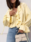 FJØRNA women's satin blouse featuring ruffle details, stylish top with smooth fabric and elegant design.