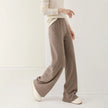 FJØRNA women's merino wool wide-leg jogger pants, soft and cozy knit fabric, relaxed fit with elastic waistband, in neutral color.