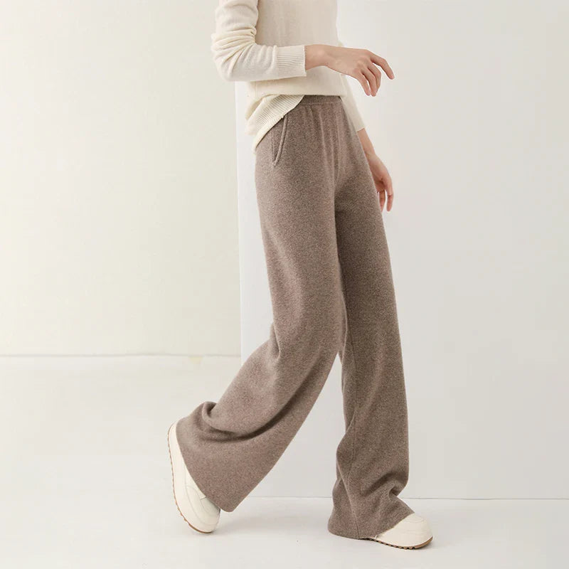 FJØRNA women's merino wool wide-leg jogger pants, soft and cozy knit fabric, relaxed fit with elastic waistband, in neutral color.