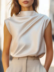 FJØRNA women's high-neck sleeveless summer blouse, stylish and lightweight top perfect for warm weather, shown on a model.