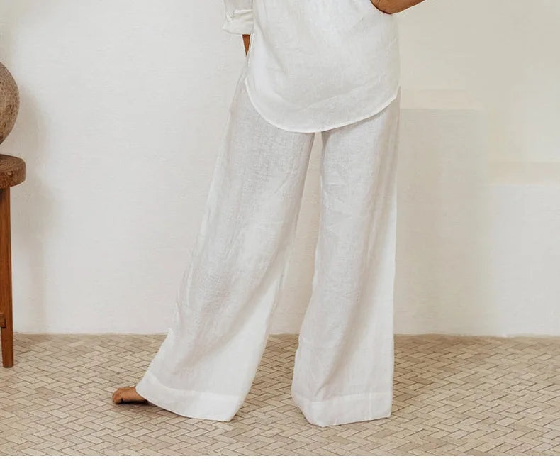 FJØRNA women's linen top with ruffle details, lightweight and breathable, shown in a soft, natural fabric with stylish ruffle accents.