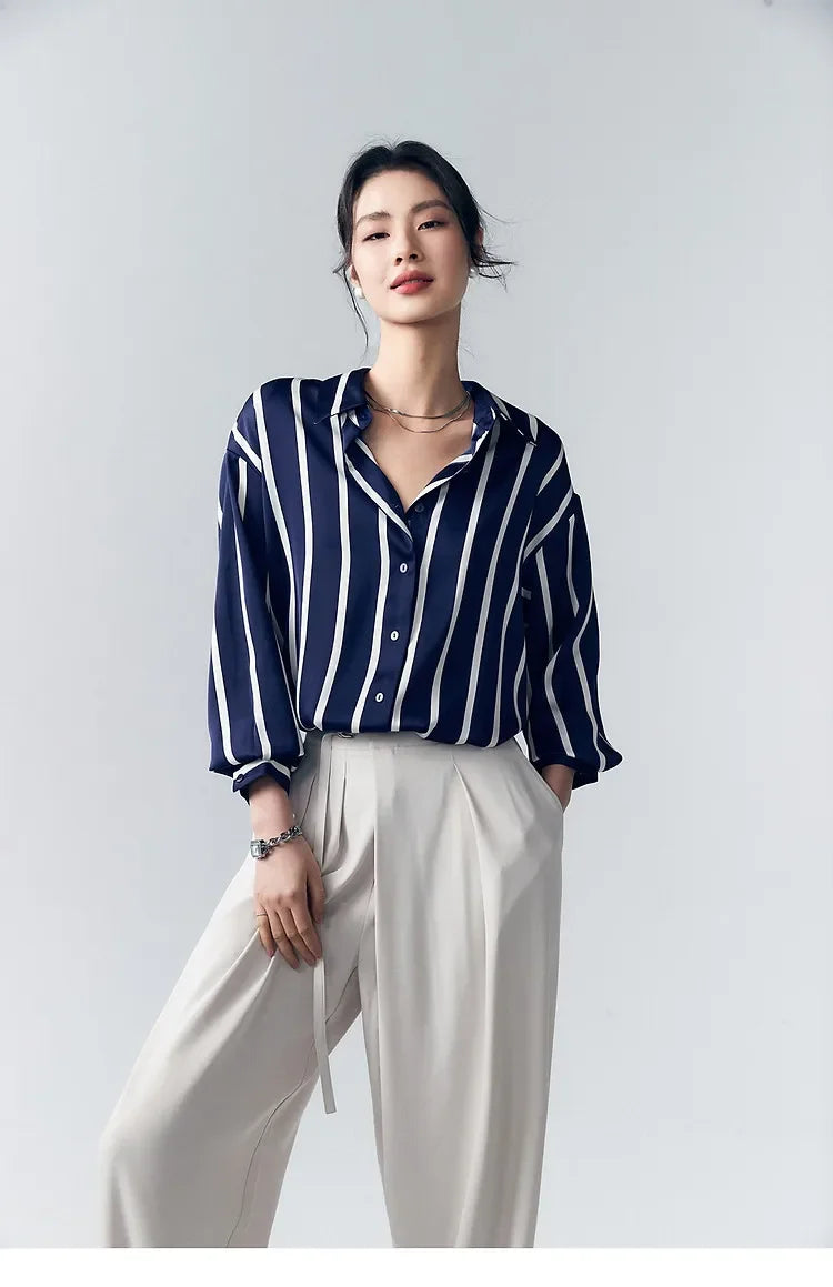 Lacceti Maren Stripe Satin Blouse featuring a relaxed fit, with white and navy stripes, long sleeves, and a silky satin finish.