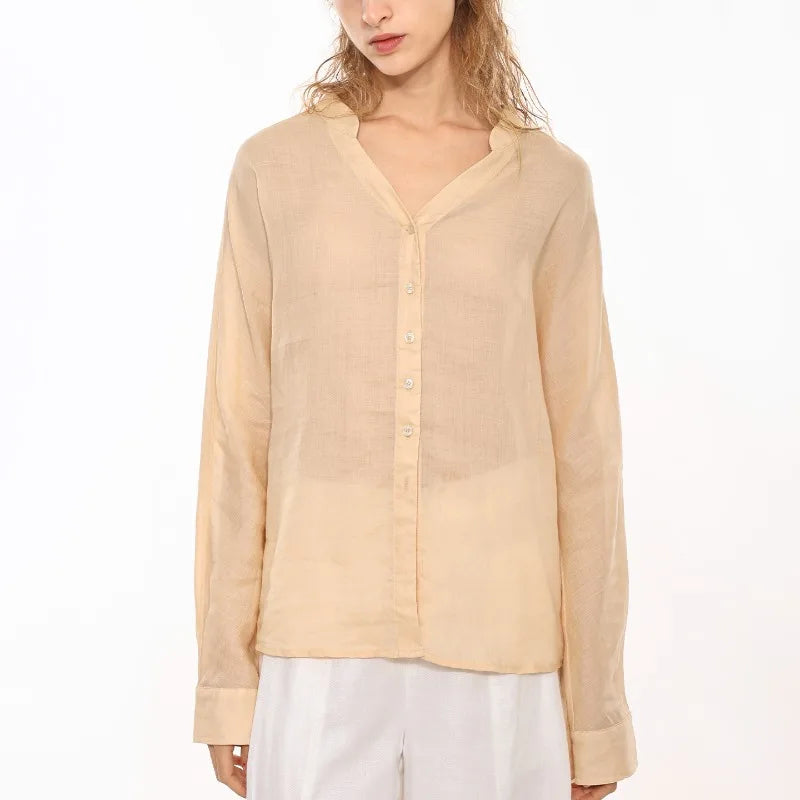 FJØRNA women's linen V-neck shirt, lightweight and breezy, shown in a relaxed fit with long sleeves and natural linen fabric.