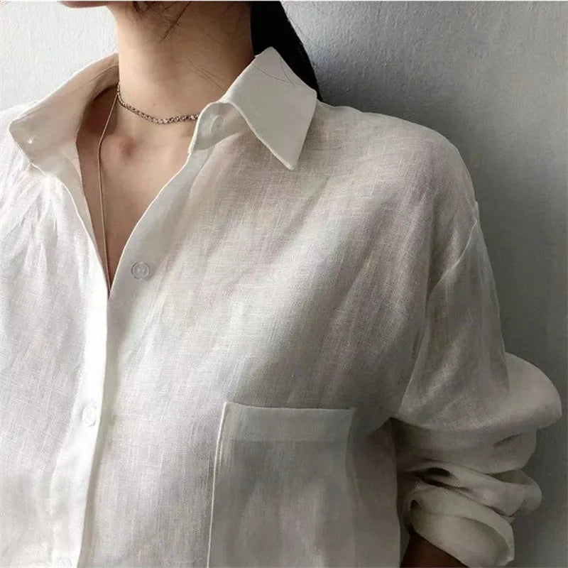 FJØRNA women's linen shirt with open collar, lightweight and breathable top, casual style, shown in a natural fabric and relaxed fit.