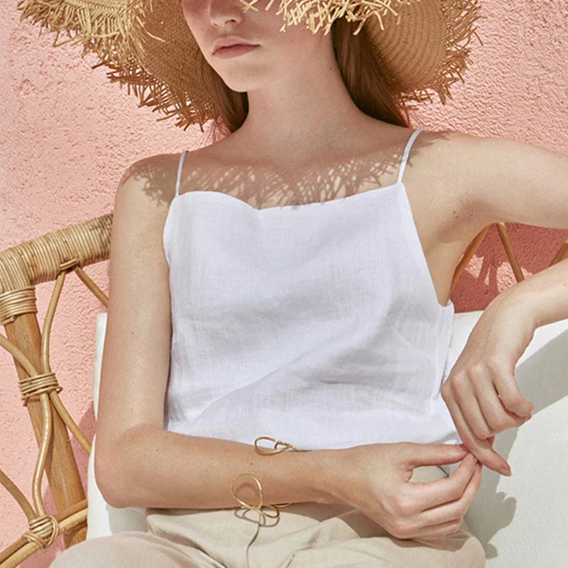 FJØRNA satin-trimmed linen cami top with delicate straps, light and breathable fabric, shown in a natural beige color.