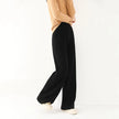 FJØRNA women's Merino wool wide-leg jogger pants, soft and comfortable for casual wear, shown in a relaxed fit.
