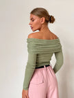 FJØRNA women's ribbed knit off-shoulder top, close-up of soft textured fabric and stylish neckline on a white background.