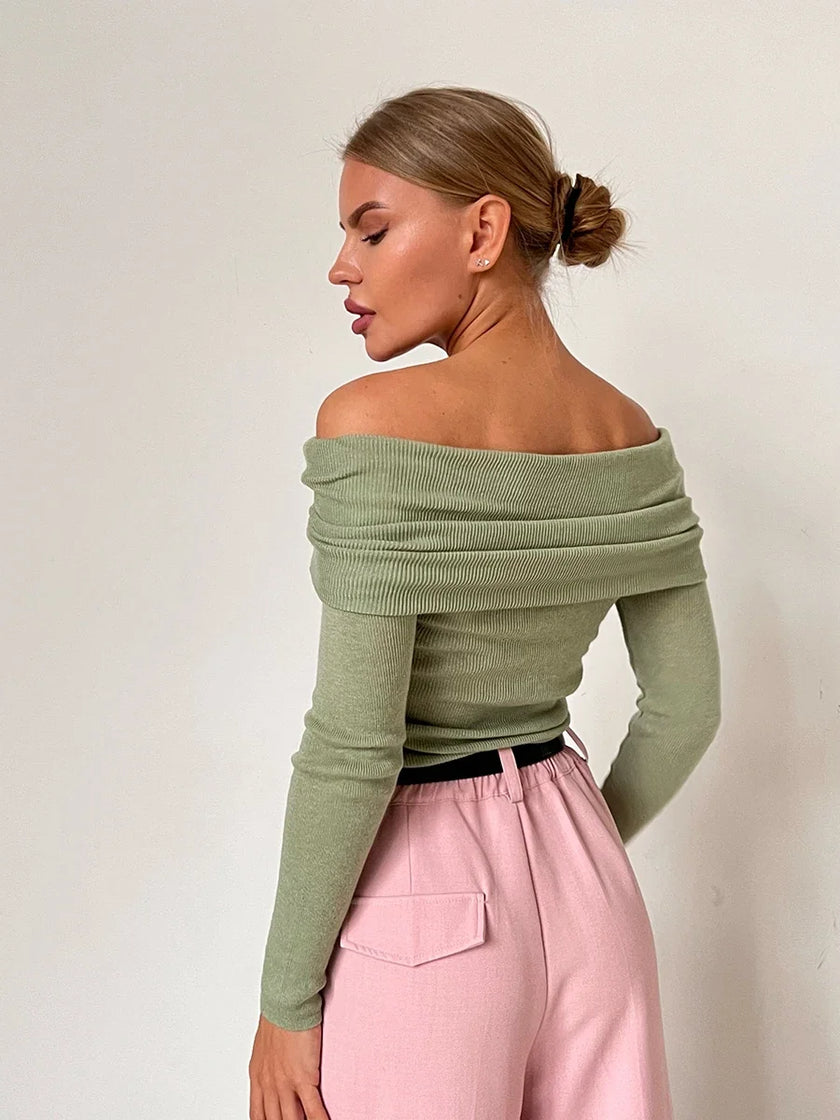 FJØRNA women's ribbed knit off-shoulder top, close-up of soft textured fabric and stylish neckline on a white background.
