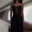 FJØRNA women’s sleeveless linen dress displayed on a hanger with a relaxed fit and natural fabric texture.