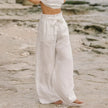 FJØRNA women's linen top with ruffle detail, lightweight and breathable, shown in a soft, natural fabric with stylish ruffle accents.
