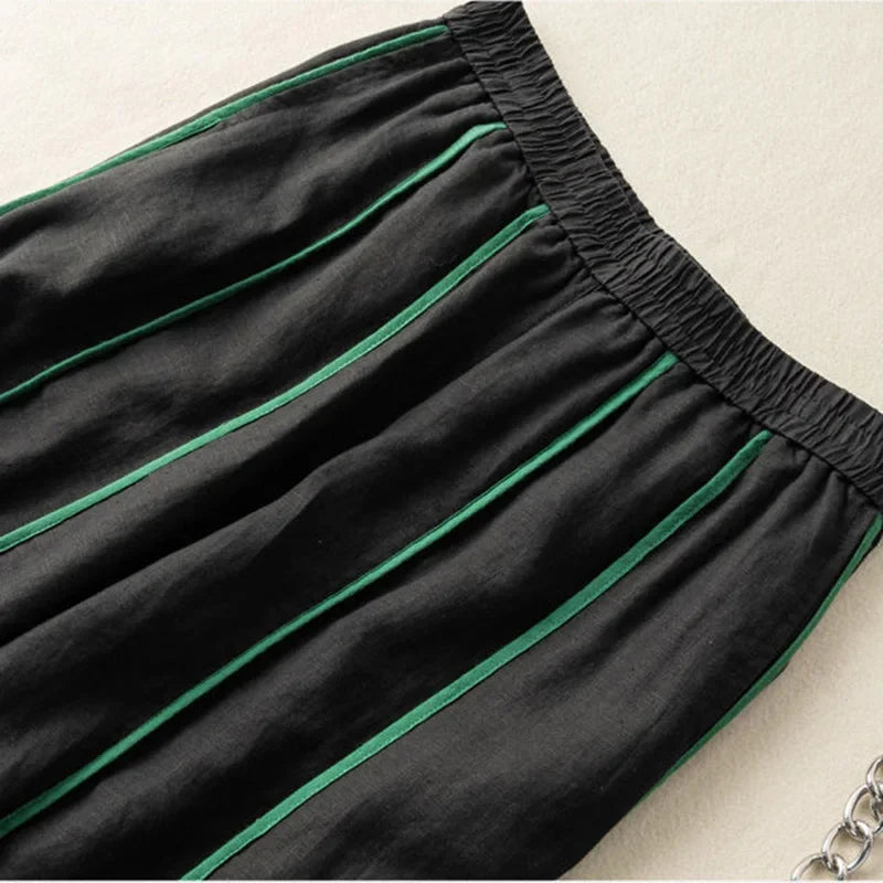 FJØRNA women's linen wide-leg trousers with elastic waist, featuring a relaxed fit and natural fabric for comfortable style.