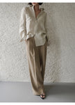 FJØRNA women's linen shirt with pleated design, long sleeves, and classic collar, shown in a light, breathable fabric.