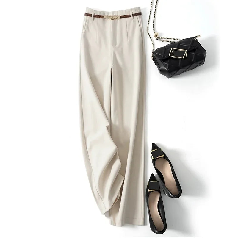 FJØRNA women’s wide-leg high-waist wool trousers with a relaxed fit and tailored design, shown on a model.