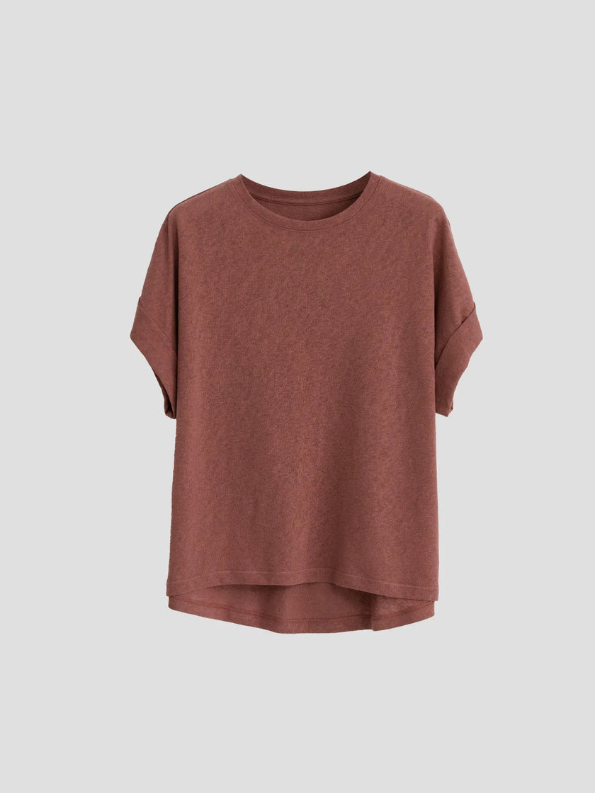 FJØRNA oversized tee with rolled cuffs, soft fabric, relaxed fit, displayed on a hanger against a neutral background