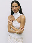 FJØRNA women's silk halter neck top, stylish and elegant, shown in a close-up of the smooth, shiny fabric and halter neckline.