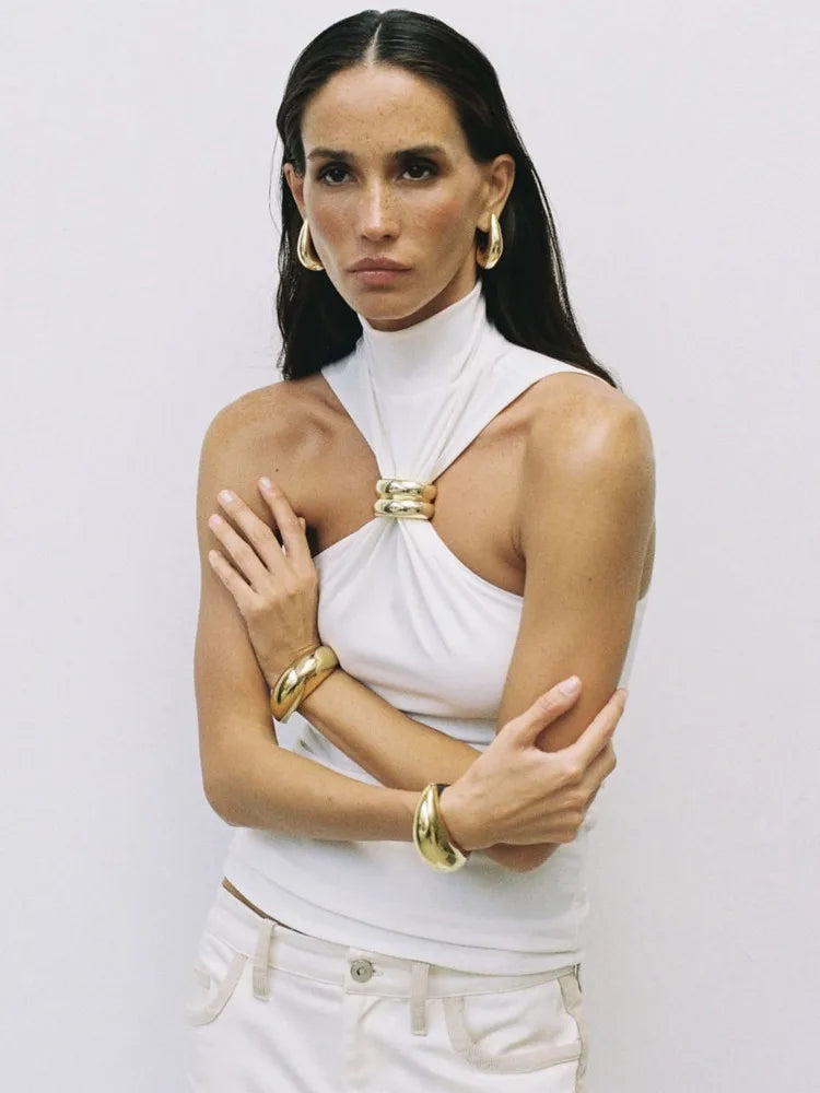 FJØRNA women's silk halter neck top, stylish and elegant, shown in a close-up of the smooth, shiny fabric and halter neckline.